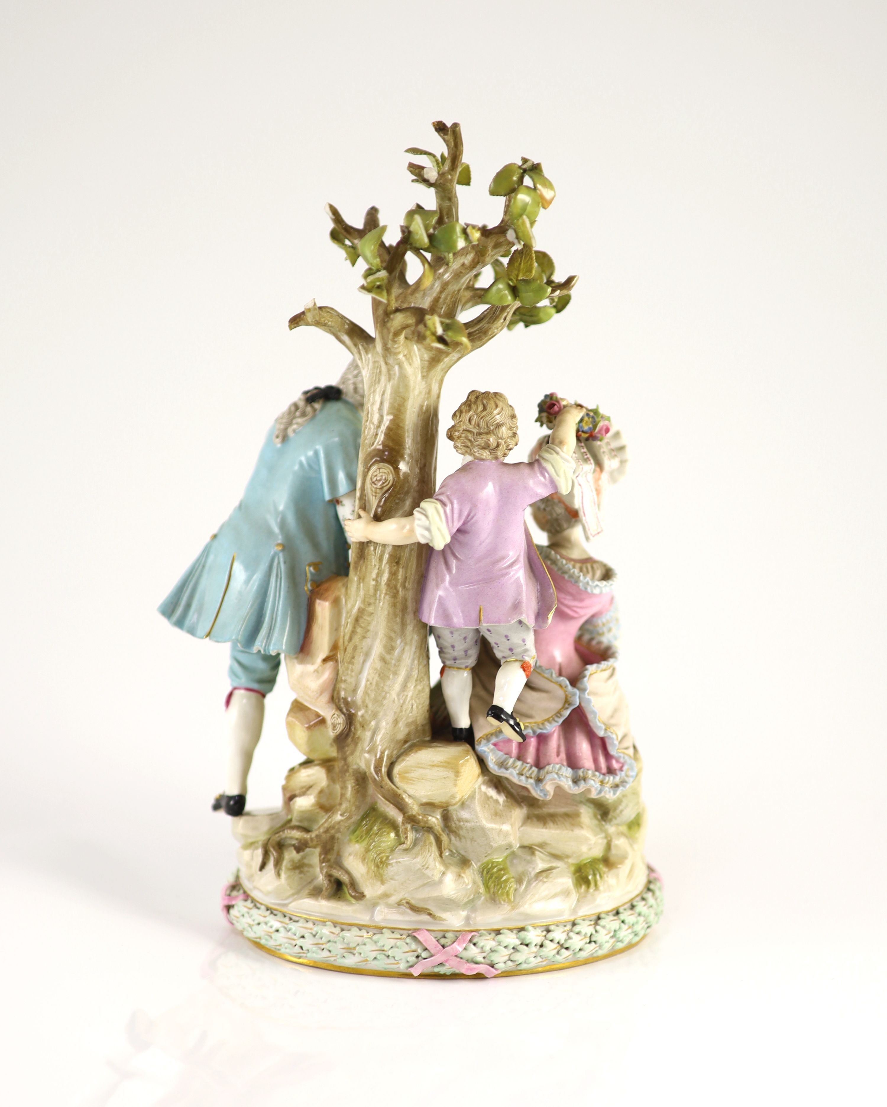 A Meissen group of flower pickers, 19th century, 26 cm high, losses to tree